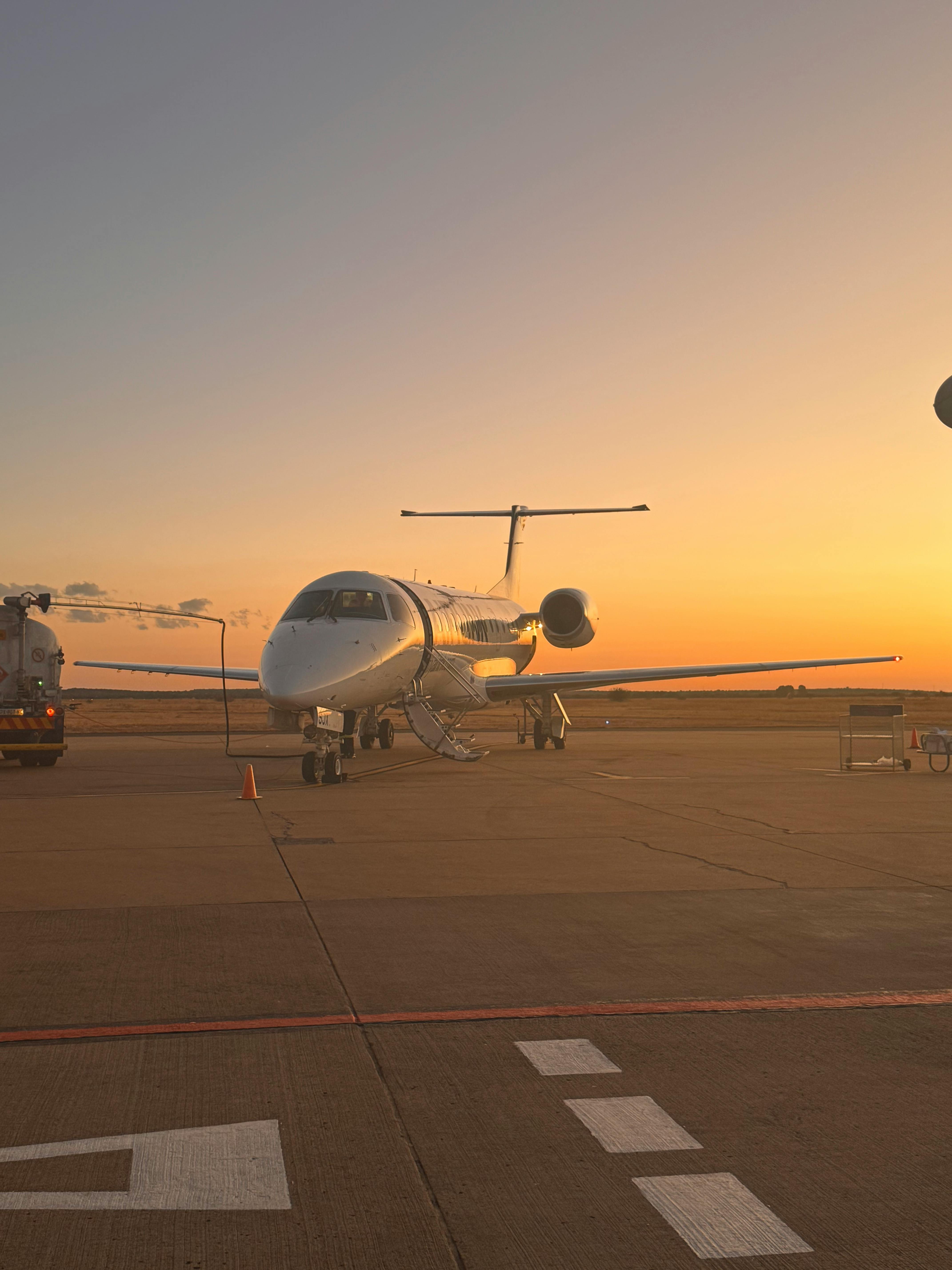 Private jet on tarmac at sunset